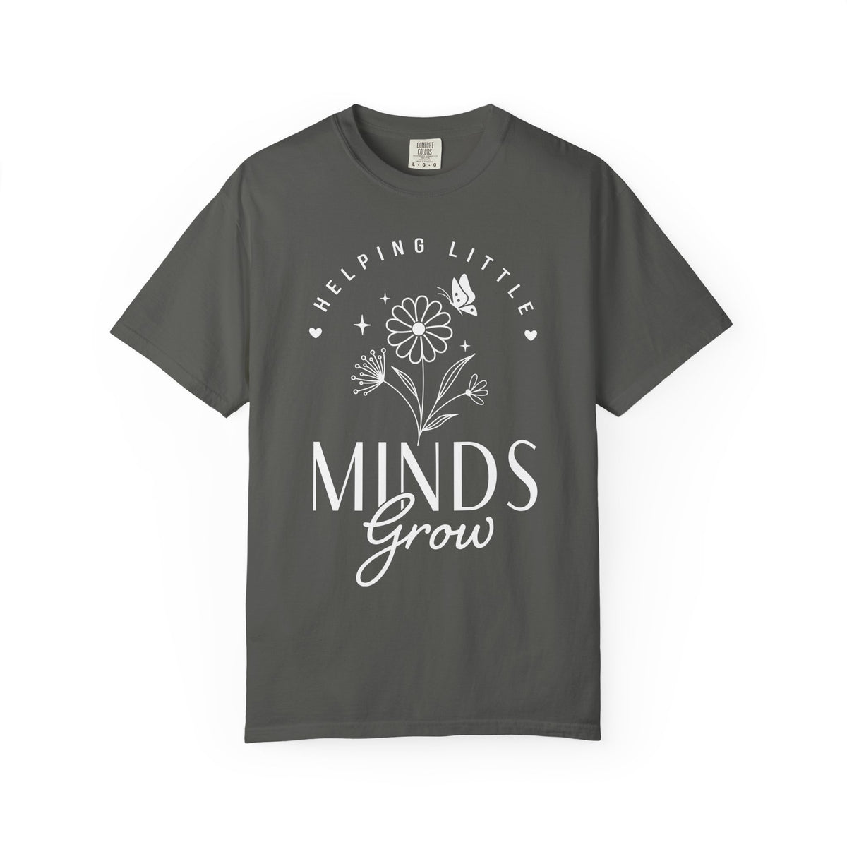 A dark gray crewneck t-shirt with a white graphic print on the front that reads 'HELPING LITTLE MINDS Grow' with a flower and butterfly illustration, shown on a plain gray background.