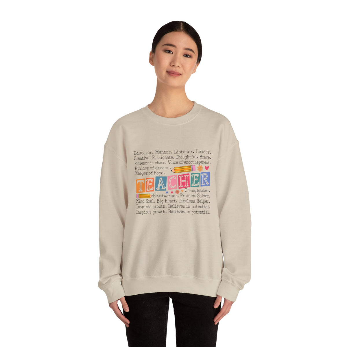 Person wearing a beige sweatshirt with colorful text design on a white background