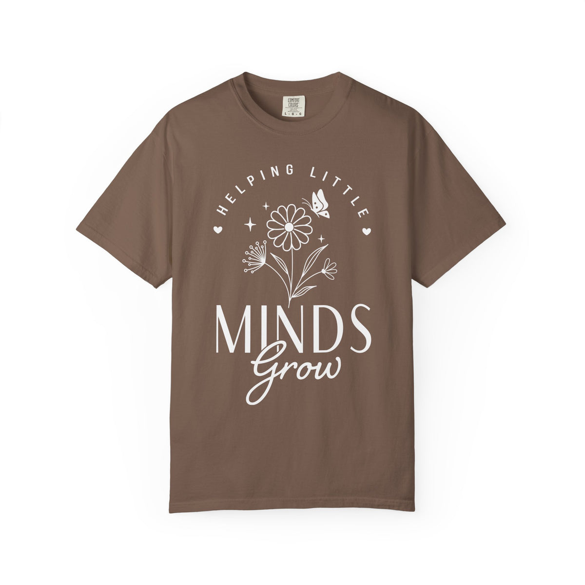 A brown short-sleeve crewneck t-shirt with a white graphic print on the front that reads 'HELPING LITTLE MINDS Grow' with a flower and butterfly illustration, shown on a plain white background.