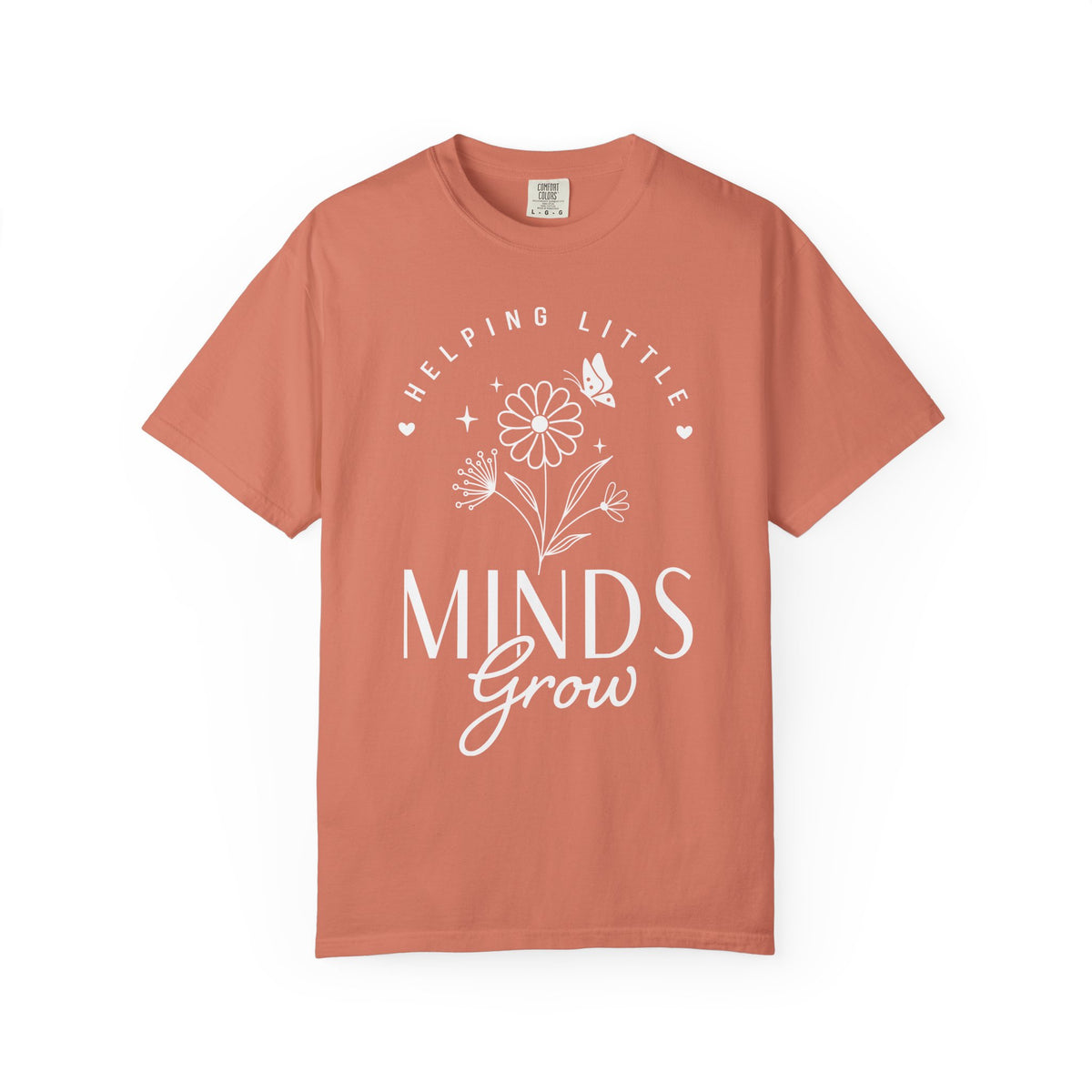 A terracotta-colored short-sleeve t-shirt with a white graphic print on the front that reads 'HELPING LITTLE MINDS Grow' with a flower and butterfly design, displayed on a clean white background.