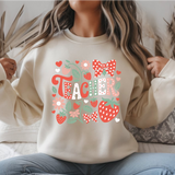Person wearing a beige sweatshirt with colorful patterns and text.