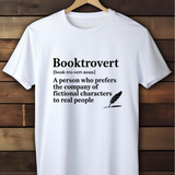 White t-shirt with 'Booktrovert' definition text on a wooden background