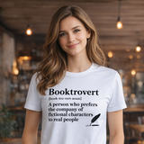 Woman wearing a white t-shirt with 'Booktrovert' definition in a casual setting