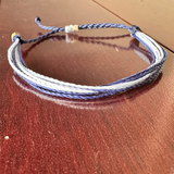 Multicolored braided bracelet on a wooden surface