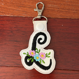 Keychain with floral design on a wooden surface