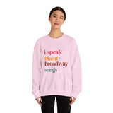 Person wearing a pink sweatshirt with colorful text on a white background