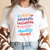 Person wearing a white t-shirt with colorful text on a beige background