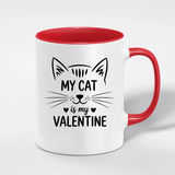 White mug with red interior and handle featuring a cat illustration and text on a white background