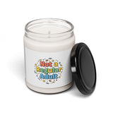 Candle in a clear jar with a colorful label on a white background