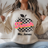 Person wearing a white sweatshirt with 'Teach' and 'Ms. Jones' text design.