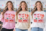 Three images of a person wearing a sweatshirt with a colorful design in different colors.