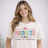 Woman wearing a t-shirt with 'Kindness is free' text design.