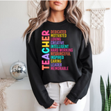 Person wearing a black sweatshirt with colorful text in a room with decor elements.