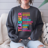 Person wearing a dark gray sweatshirt with colorful text on a light wooden background