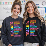 Two women wearing sweatshirts with colorful text in a classroom setting