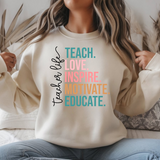 Person wearing a beige sweatshirt with colorful text on a white background