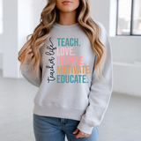 Person wearing a gray sweatshirt with colorful text in a bright room.