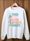 White sweatshirt with colorful text on a wooden hanger against a wooden background