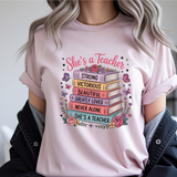 Person wearing a pink t-shirt with a colorful graphic and text.