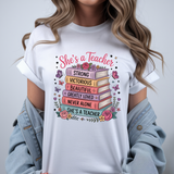 Person wearing a white t-shirt with a colorful design and text on a gray background