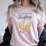 Person wearing a pink t-shirt with 'I'd Rather Be Thrifting' graphic and text.