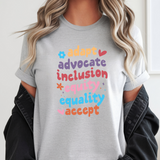 Person wearing a gray t-shirt with colorful text on a white background